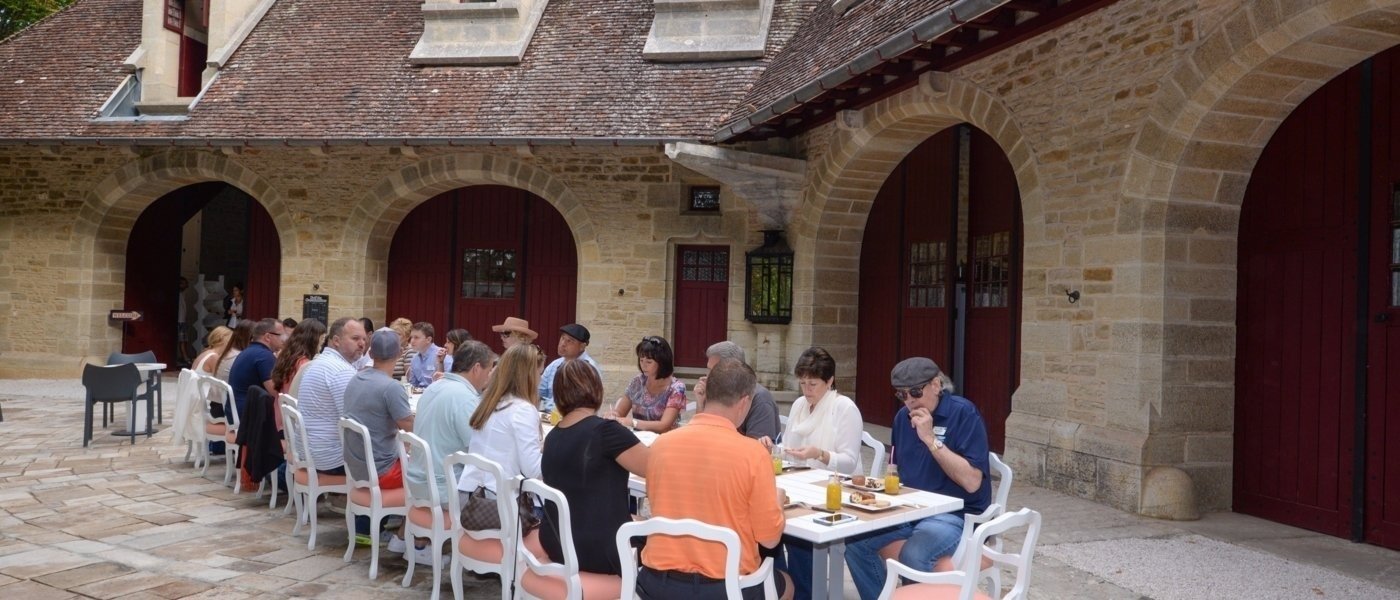 people eating outside of a Château in Burgundy - Wine Paths
